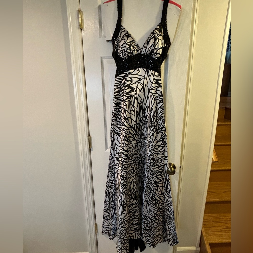 Black and white gown. Small black train. Criss cross sequin straps. Open back